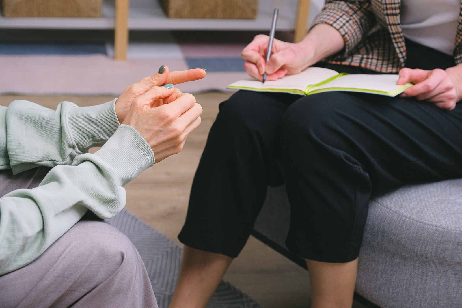 female doctor and client sitting in armchairs during session in modern office