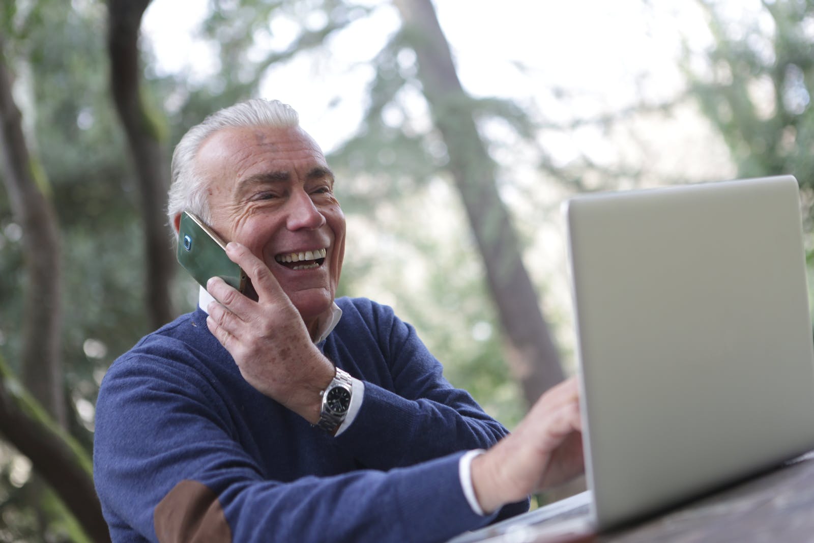 Man in Blue Long Sleeve Sweater Using Cellphone Ayurveda for Seniors