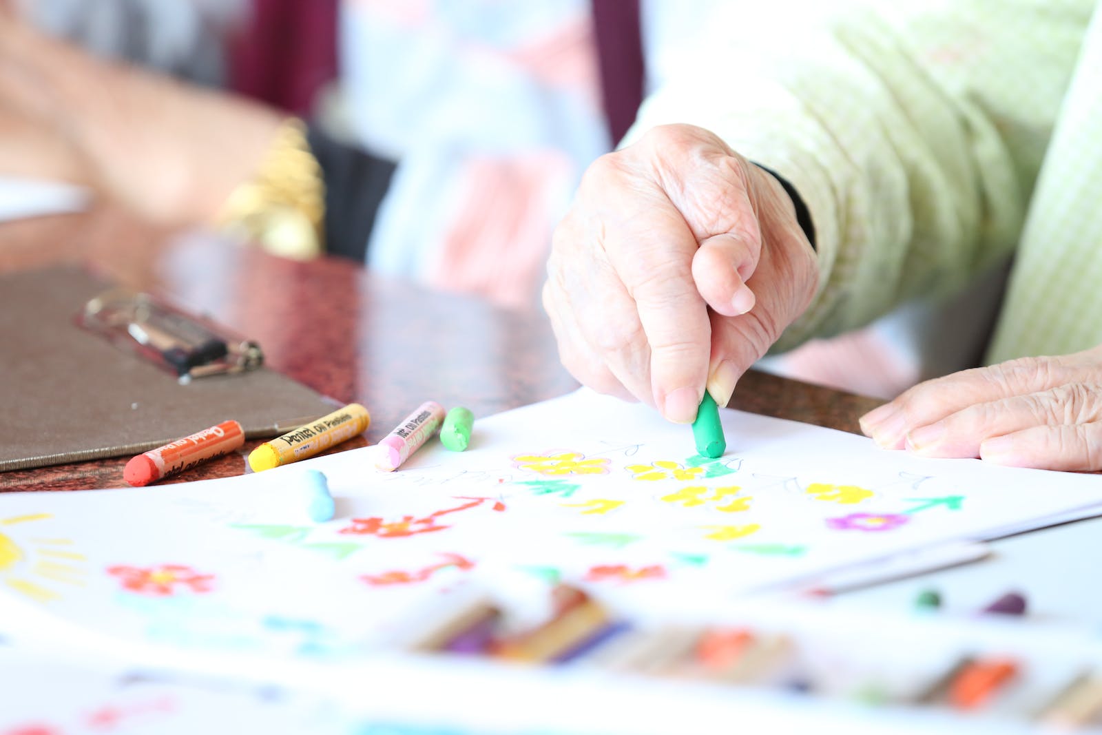 Crop elderly patient with crayons Benefits of Art Therapy for Seniors