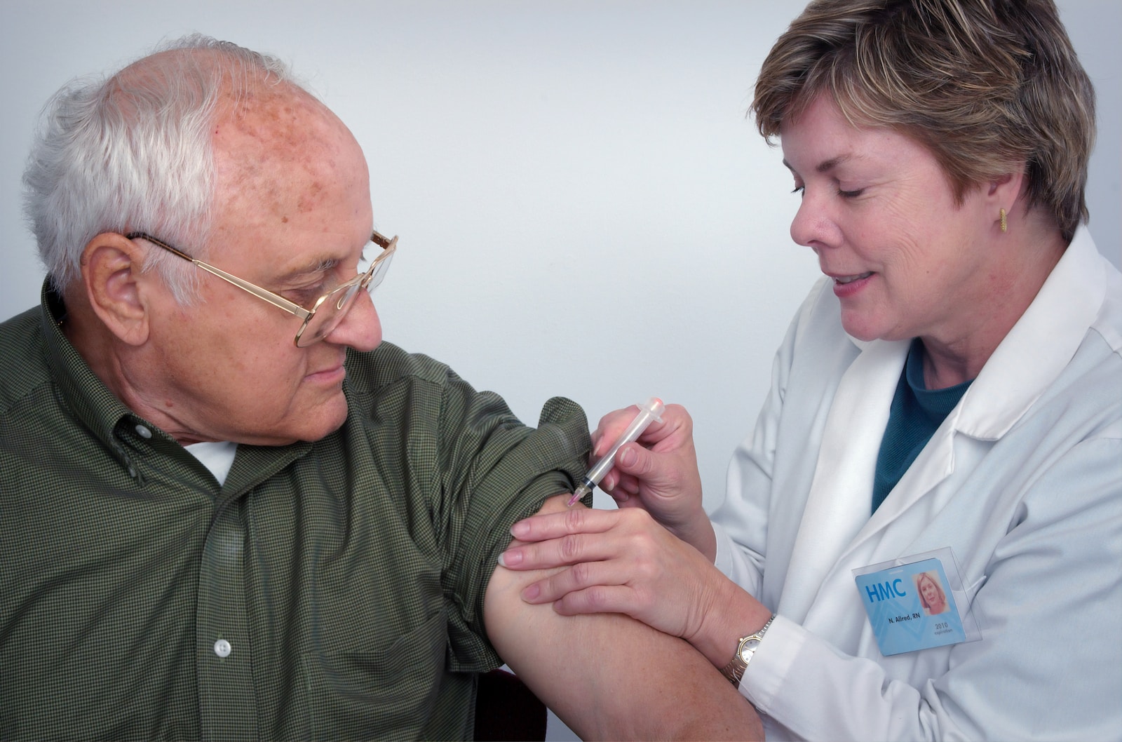 woman injecting syringe on mans arm Naturopathy in Senior Health