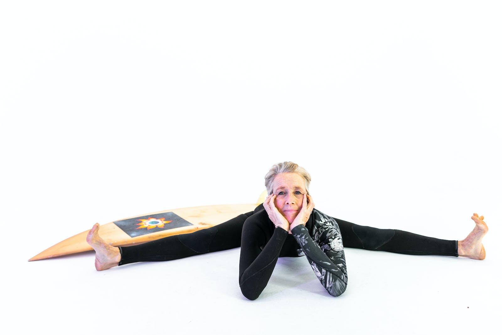 Woman in Black Active Wear With Legs Stretched On Floor Physical Therapy in Maintaining Senior