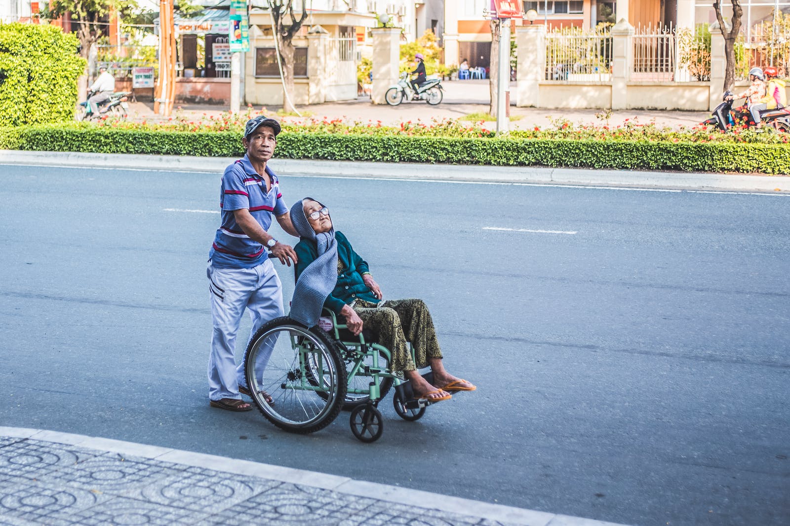 Man Pushing A Woman Sitting on Wheelchair Utilizing Respite Care
